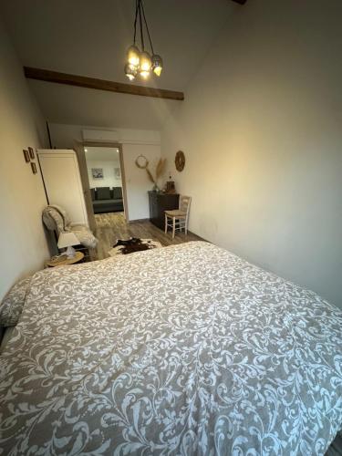 a bedroom with a large bed in a room at La maisonnette de Chantecoucou in Le Cannet-des-Maures