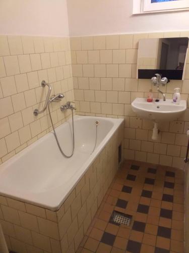 a bathroom with a tub and a sink at rodinný dům in Třebíč