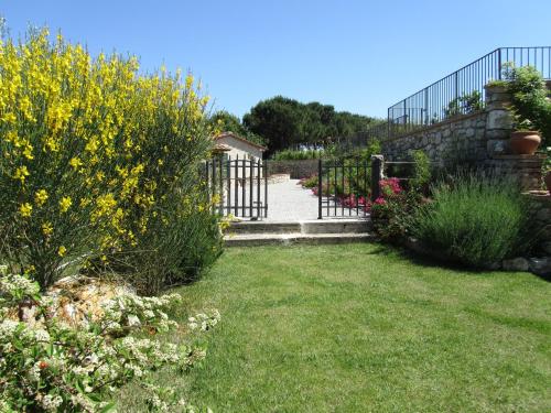 a garden with a gate and some flowers at Agriturismo Borghetto Il Montino in Rapolano Terme