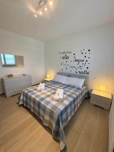 a bedroom with a bed with two towels on it at A casa mia in Modena
