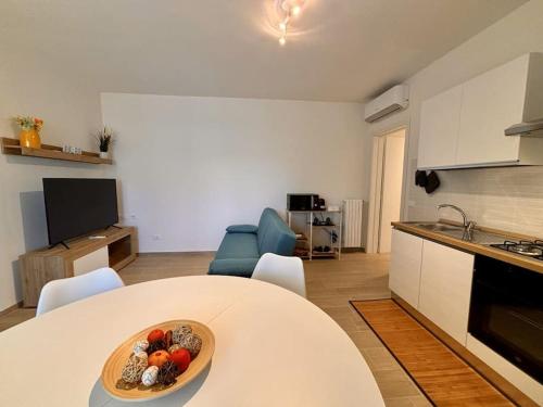 a kitchen with a table with a bowl of fruit on it at A casa mia in Modena