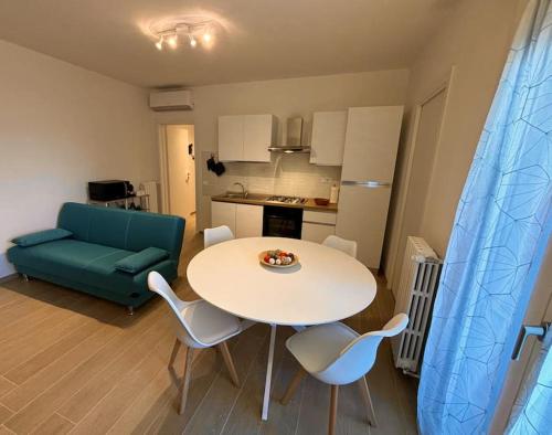 a living room with a table and chairs and a couch at A casa mia in Modena