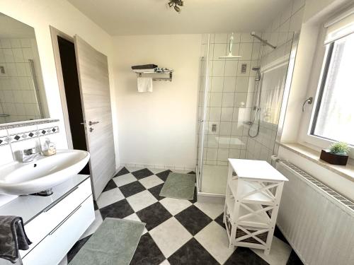 a white bathroom with a sink and a shower at Ferienwohnung Anita in Jandelsbrunn