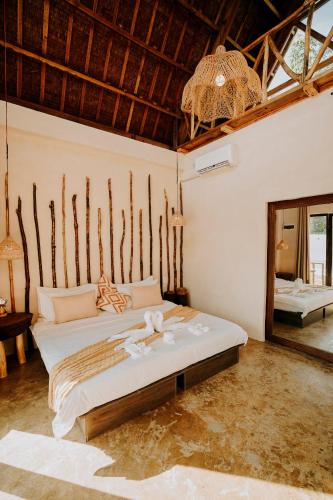 a bedroom with a large bed in a room at NYLA Boutique Resort Siargao in General Luna