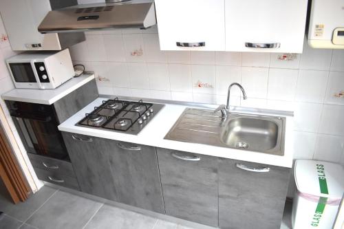 a small kitchen with a sink and a stove at Panoramical appartment Lecco in Lecco