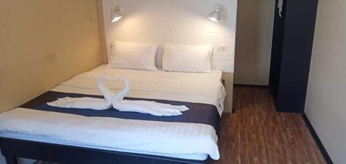a hotel room with a bed with towels on it at Infinity Boutique Hotel Kata Beach in Kata Beach