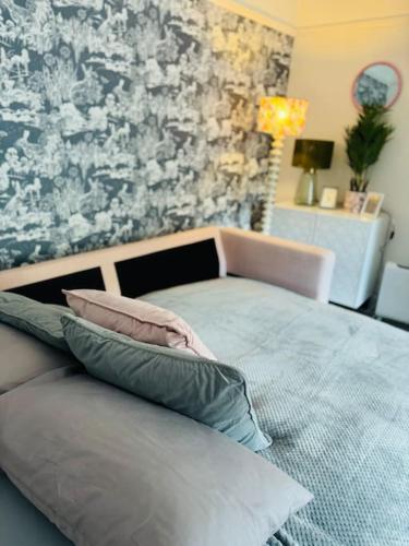 a bedroom with a bed with pillows on it at Gorge Nest in Cheddar Gorge in Cheddar