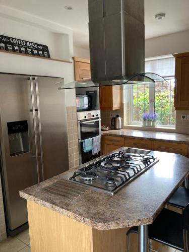 a kitchen with a stove top and a refrigerator at St Marys House in Norwich