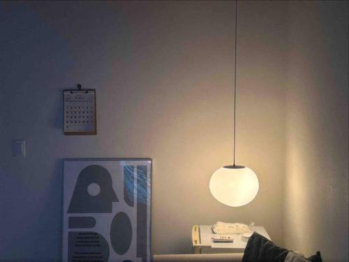 a light hanging from the ceiling in a living room at Hanok village private house with jacuzzi Aboy in Jeonju