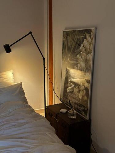 a bedroom with a bed and a lamp on a dresser at Hanok village private house with jacuzzi Aboy in Jeonju