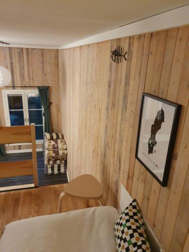 a living room with a bed and a spider on the wall at Kulturhuset Blåsmark in Piteå