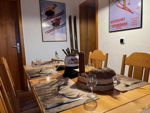 a wooden table with a cake on top of it at Casa Tresch Sedrun Tujetsch bis 5 Pers in Sedrun