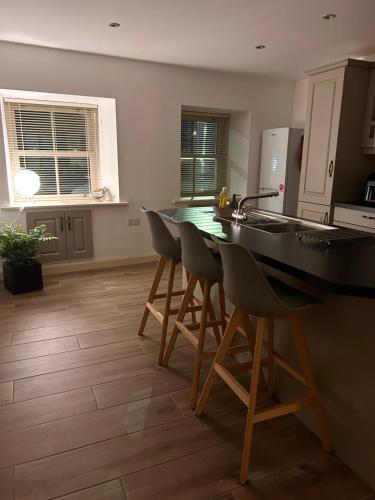 a kitchen with a table and chairs in a kitchen at The Parlour Cottage in Galway