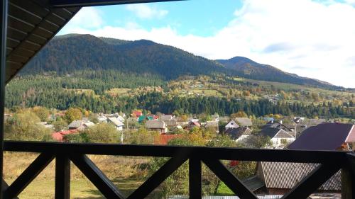 a view from a balcony of a village in the mountains at Синевирський Краєвид in Synevyr