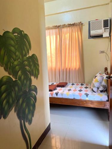 a bedroom with a bed and a window with bananas at C View Resort in Sipalay