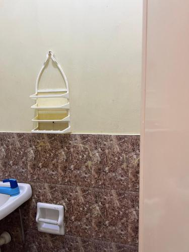 a bathroom with a towel rack and a sink at C View Resort in Sipalay