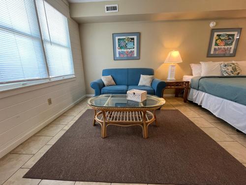 a living room with a bed and a couch and a coffee table at Cape Hatteras Motel in Buxton