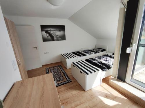 a small room with two beds and a table at Ferienwohnung "Zur alten Schreinerei" Gundelfingen - Donau in Gundelfingen an der Donau