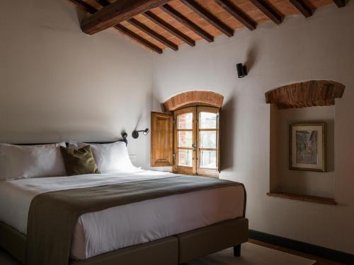 Postel nebo postele na pokoji v ubytování Borgo San Vincenzo