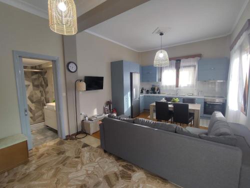 a living room with a couch and a kitchen at Myron & Gabby's House in Monemvasia