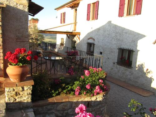 a building with flowers in front of it at Agriturismo Borghetto Il Montino in Rapolano Terme