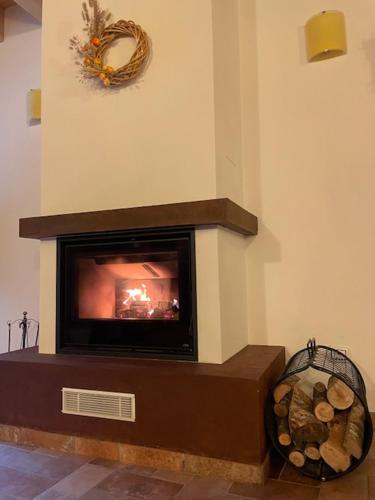 a fireplace in a living room with a wreath on the wall at Le Logge del Garda in San Felice del Benaco