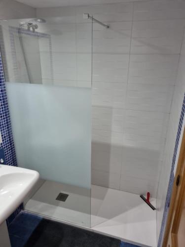 a shower with a glass door next to a sink at Place-To-Relax in San Luis de Sabinillas