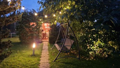a garden at night with a swing and lights at Rekreační chalupa Pištín in Pištín