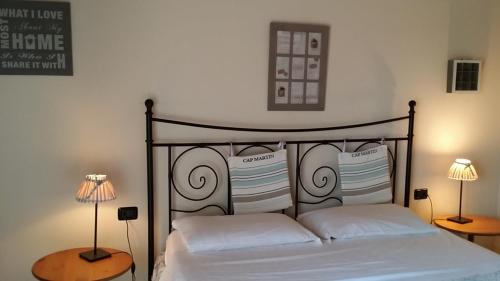 a bedroom with a bed with two lamps on two tables at Agriturismo La Fattoria Del Boschetto in Fontanellato