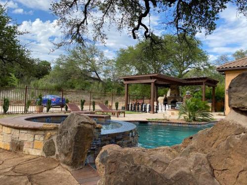 a swimming pool in a yard with a gazebo at Villa at Cibolo Chase, a private resort with pool in Bulverde