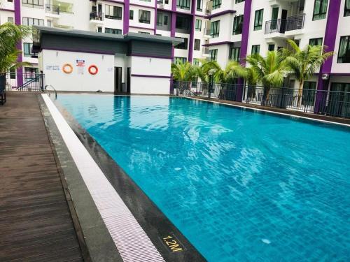 a large swimming pool in front of a building at Ayer Keroh D153A 6-8 pax Comfort Stay - GXHomes in Melaka