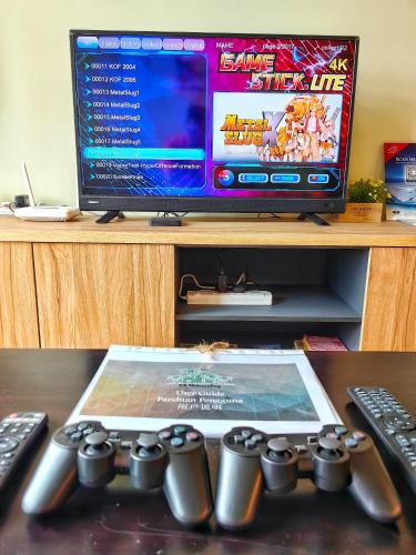 a video game controller sitting on top of a desk at Ayer Keroh D153A 6-8 pax Comfort Stay - GXHomes in Melaka