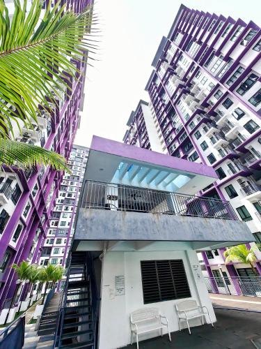 a building with two chairs in front of a tall building at Ayer Keroh D153A 6-8 pax Comfort Stay - GXHomes in Melaka