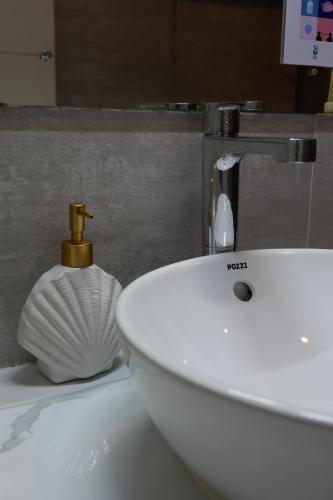 a bathroom with a sink and a white sink at Vela Terraces Hotel in Coron
