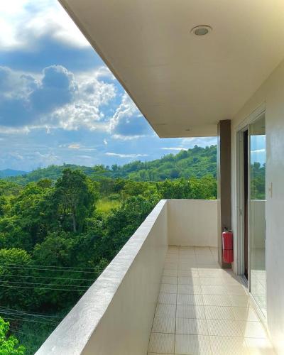 a balcony with a view of the forest at Vela Terraces Hotel in Coron