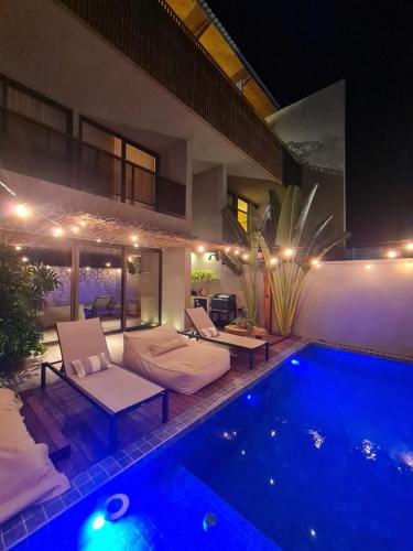 a villa with a swimming pool at night at CASA SALGA - MILAGRES - 3 mins a pé da praia da Capela in São Miguel dos Milagres