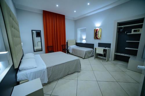 a hotel room with two beds and a desk at Hotel Demo' in Milan