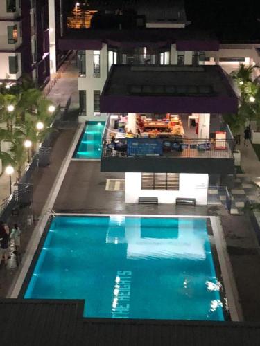 an overhead view of two swimming pools at night at Ayer Keroh D153A 6-8 pax Comfort Stay - GXHomes in Melaka
