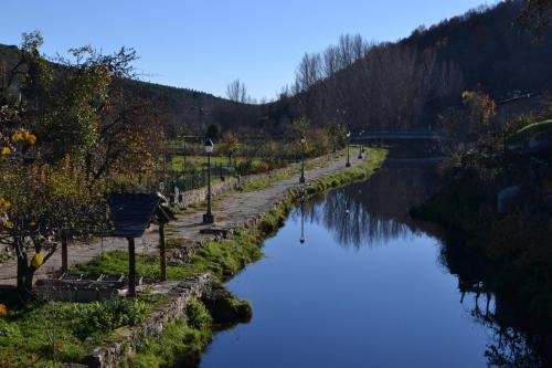 a view of a river with a bridge in the background at Casa de Onor in Rio de Onor
