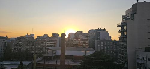 a sunset in a city with tall buildings at PALERMO APART 1 in Buenos Aires