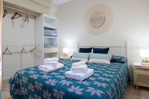 a bedroom with a bed with towels on it at Apartamento LUNADA I in Candeleda