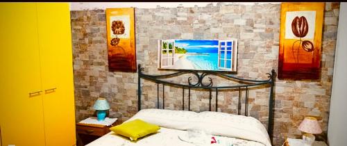 a bedroom with a bed with a picture on the wall at Villa Sant Anna in Alghero