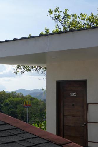 a building with a door with a view of the mountains at Vela Terraces Hotel in Coron