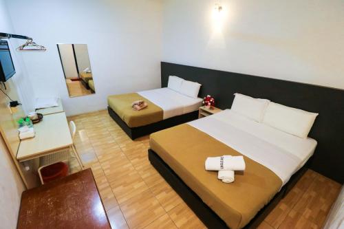 Postel nebo postele na pokoji v ubytování Uncle Guesthouse Kuala Terengganu