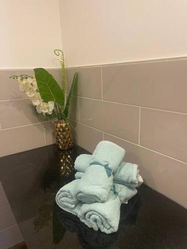 a pile of towels on a table in a bathroom at Karon Beach Large 2 bedrooms & living room Seaview apartment in Karon Beach
