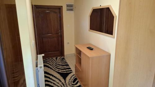 a bathroom with a wooden cabinet and a door at Santa Golija in Golija