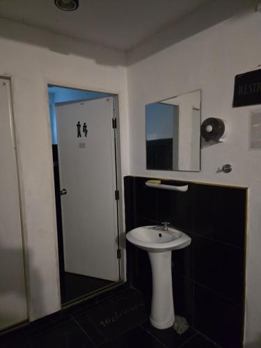 a bathroom with a white sink and a mirror at Jay Jay Guesthouse in Bangkok