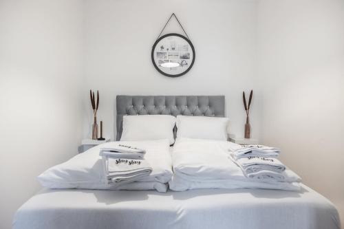 a white bedroom with a bed with white sheets at Oldtown Apartments by StayStay, close to Castle & Main Market Square in Nürnberg