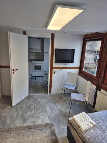 a room with a bed and a tv and a window at Altstadt Apartment mit Ausblick in Braunschweig