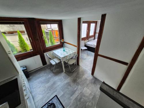 a small room with a table and a window at Altstadt Apartment mit Ausblick in Braunschweig